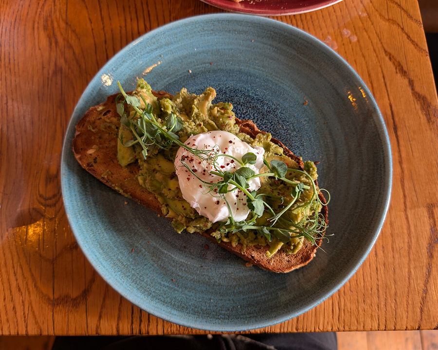 Illustrative photo: Smashed avocado on toast topped with a poached egg and herbs