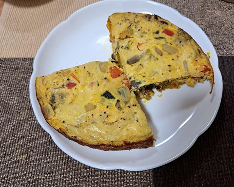 Illustrative photo: A sliced open-faced omelette with vegetables on a plate