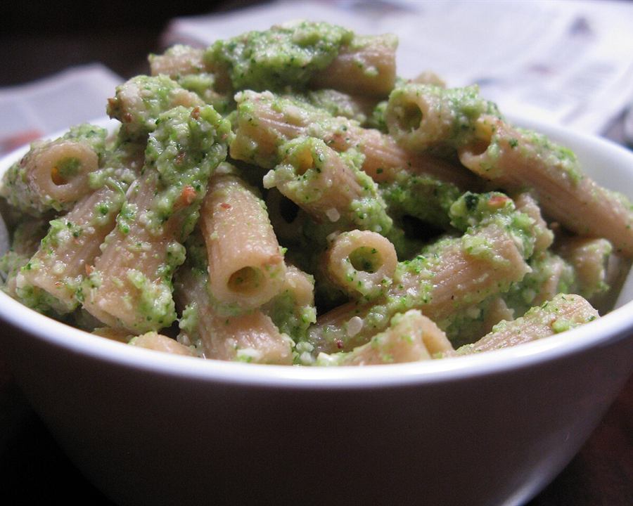 Illustrative photo: Whole-wheat pasta tossed with a green broccoli sauce in a white bowl