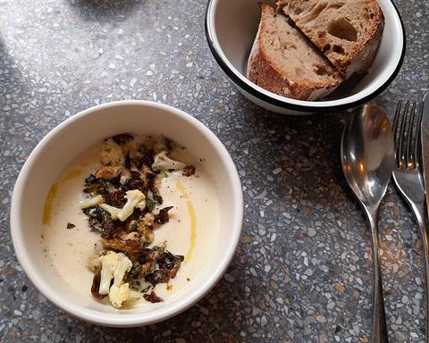 Illustrative photo: A bowl of cream of cauliflower soup topped with crisp fried leaves