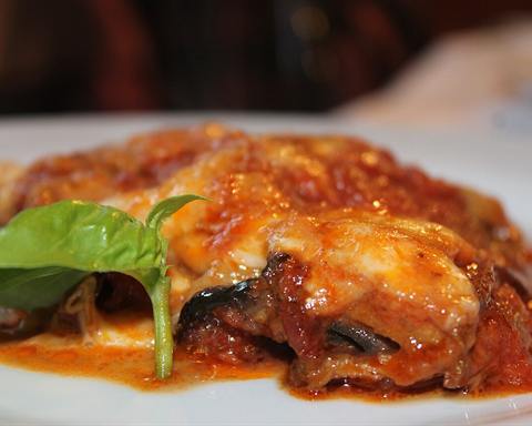 Illustrative photo: Baked aubergine (eggplant) with tomato sauce and melted cheese, with a basil leaf