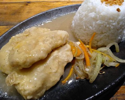 Illustrative photo: A white fish fillet with rice, carrot and onion on a serving plate