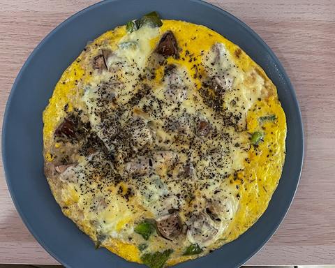 Illustrative photo: An omelette with mushrooms, peppers and cheese on a blue plate