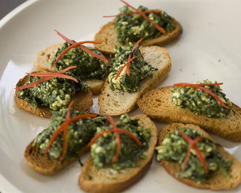 Illustrative photo: Crostini topped with a green spread and cheese