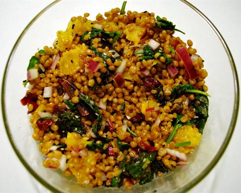 Illustrative photo: A wheat berry salad with spinach, kale, red onion and orange pieces