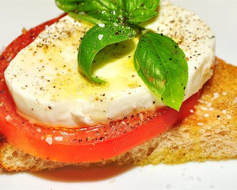 Illustrative photo: Toast topped with a tomato slice, fresh mozzarella and basil