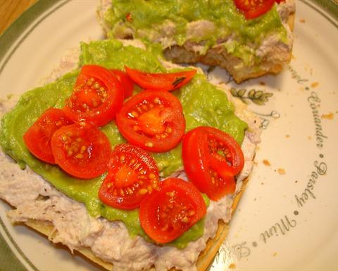 Illustrative photo: An open-faced tuna sandwich with guacamole and cherry tomatoes