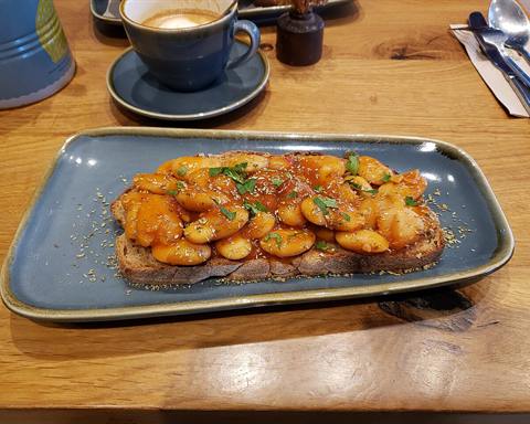Illustrative photo: Large white beans in tomato sauce, with herbs, on toast